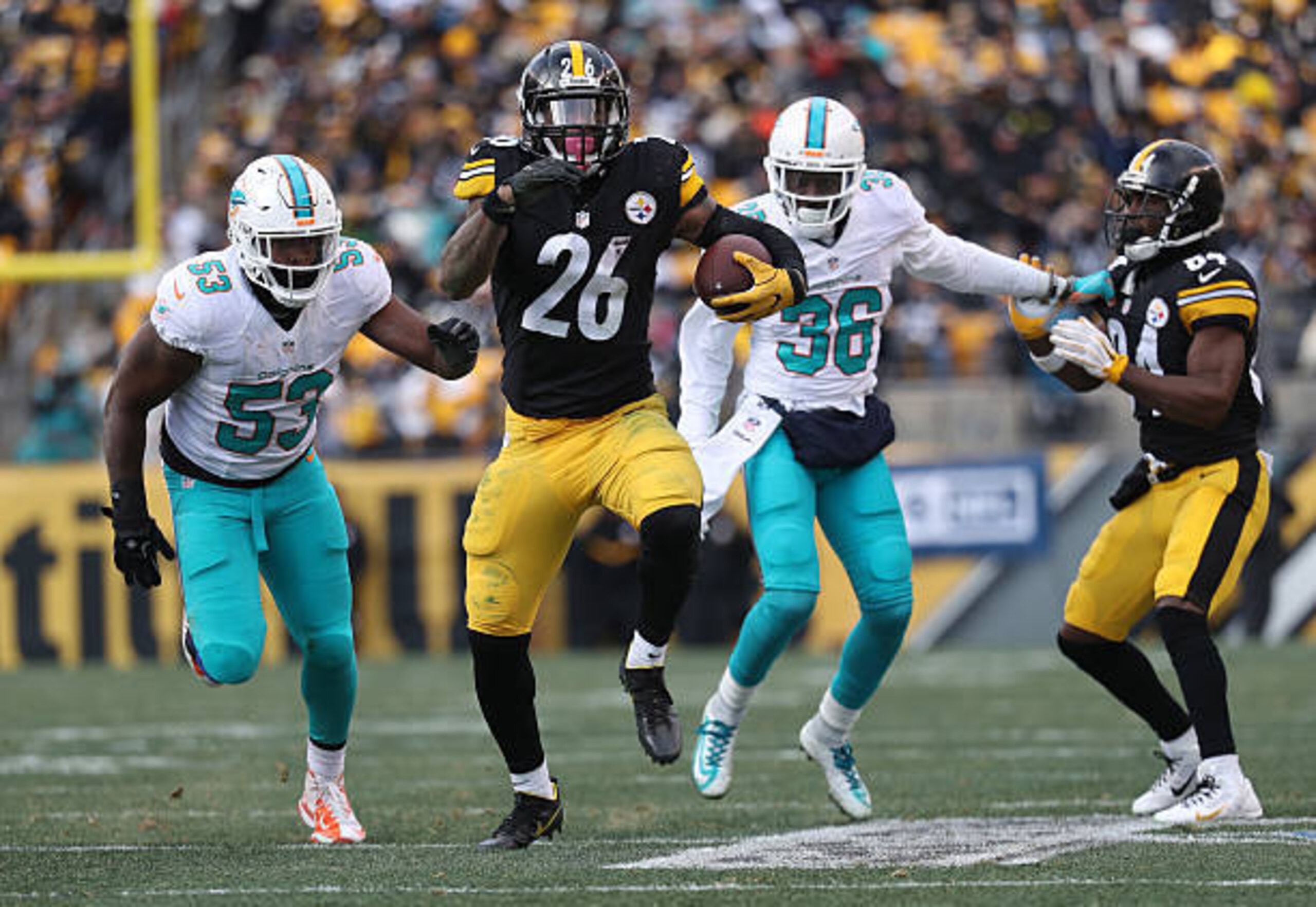 PITTSBURGH, PA - JANUARY 08:  Le'Veon Bell #26 of the Pittsburgh Steelers carries the ball during the third quarter against the Miami Dolphins in the AFC Wild Card game at Heinz Field on January 8, 2017 in Pittsburgh, Pennsylvania.  (Photo by Rob Carr/Get