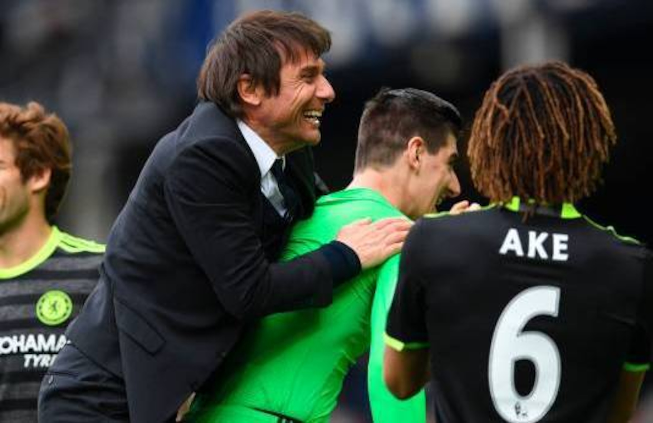 Conte launches himself on Courtois for a piggyback after victory over Everton.