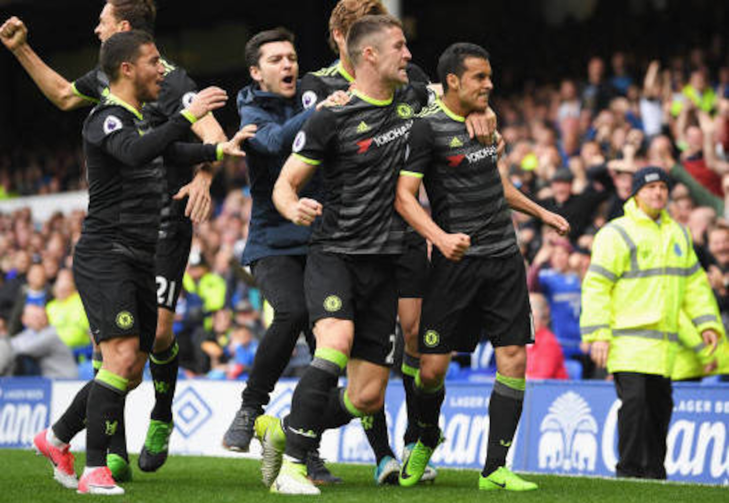 Pedro is swamped by his team-mates after his opening goal against Everton