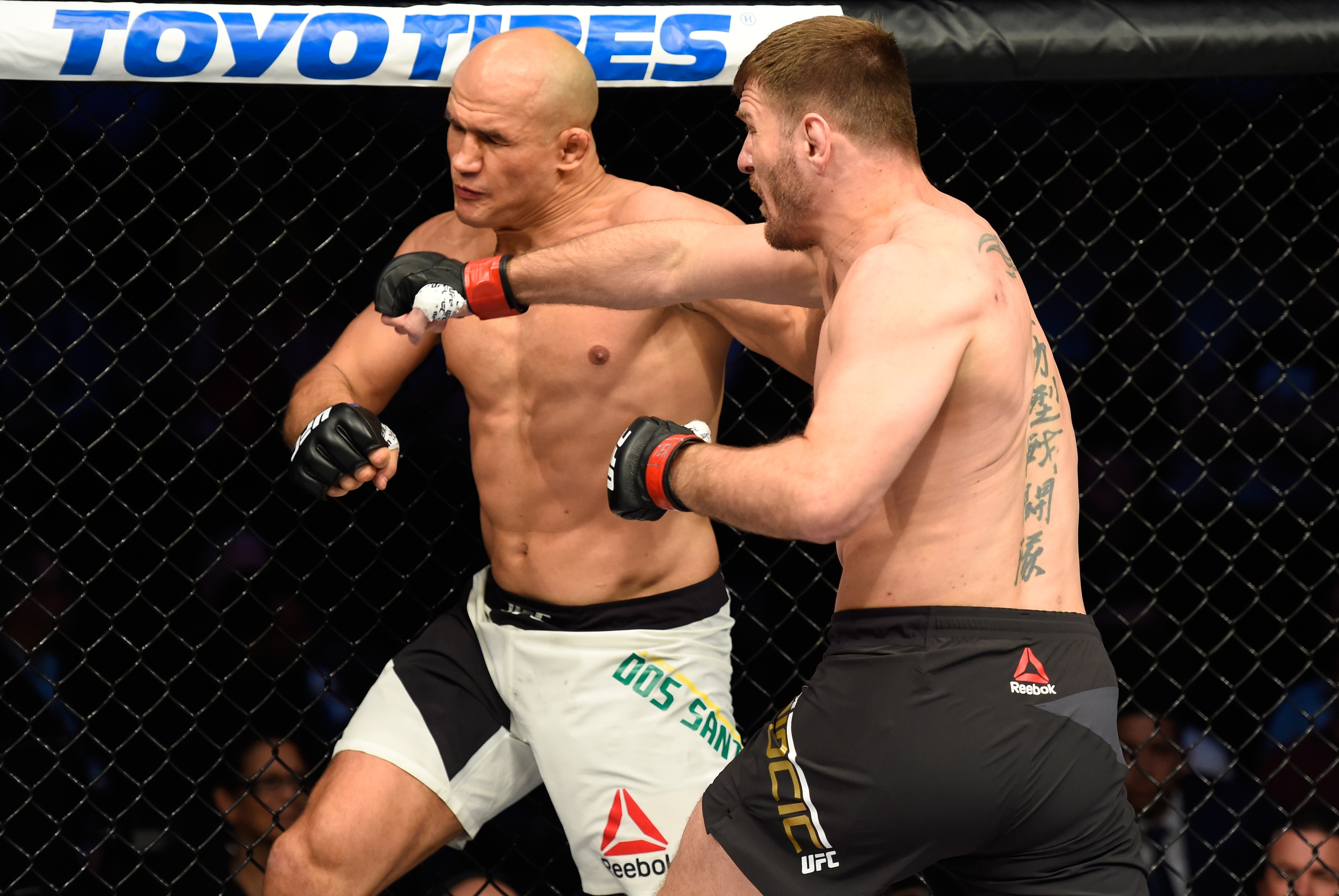 Stipe Miocic (right) hits Junior dos Santos Stipe Miocic (right) hits Junior dos Santos