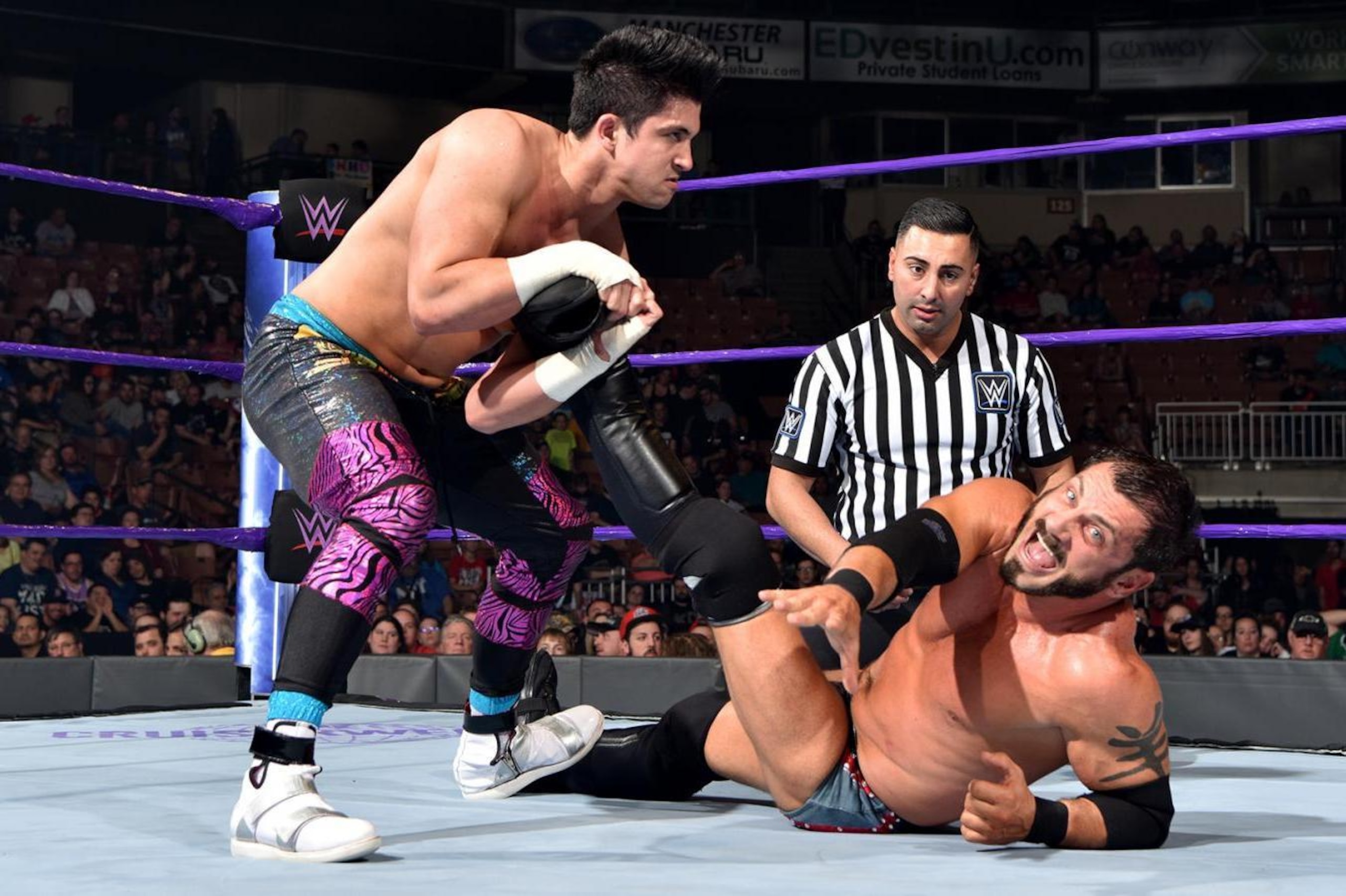 TJP working over the injured leg of Austin Aries. TJP working over the injured leg of Austin Aries.