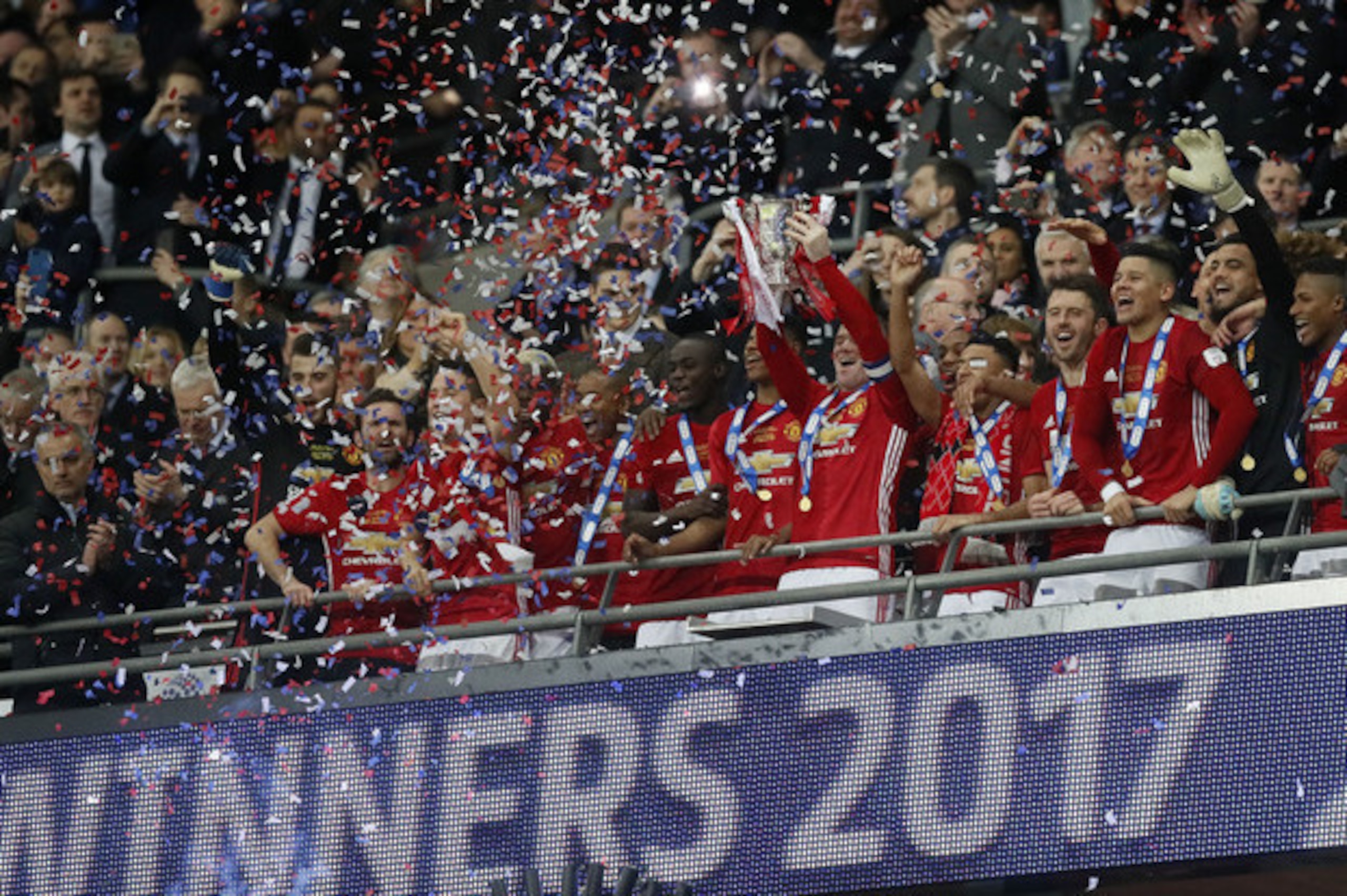 The Manchester United squad celebrate their EFL Cup win. The Manchester United squad celebrate their EFL Cup win.