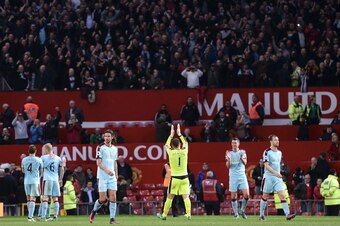 Burnley celebrate their 0-0 draw at Old Trafford.