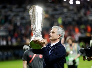 Jose Mourinho with one of the trophies he won at United this season.