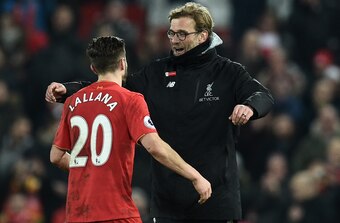 Adam Lallana (wearing No. 20) celebrates Liverpool's home win over Tottenham Hotspur.