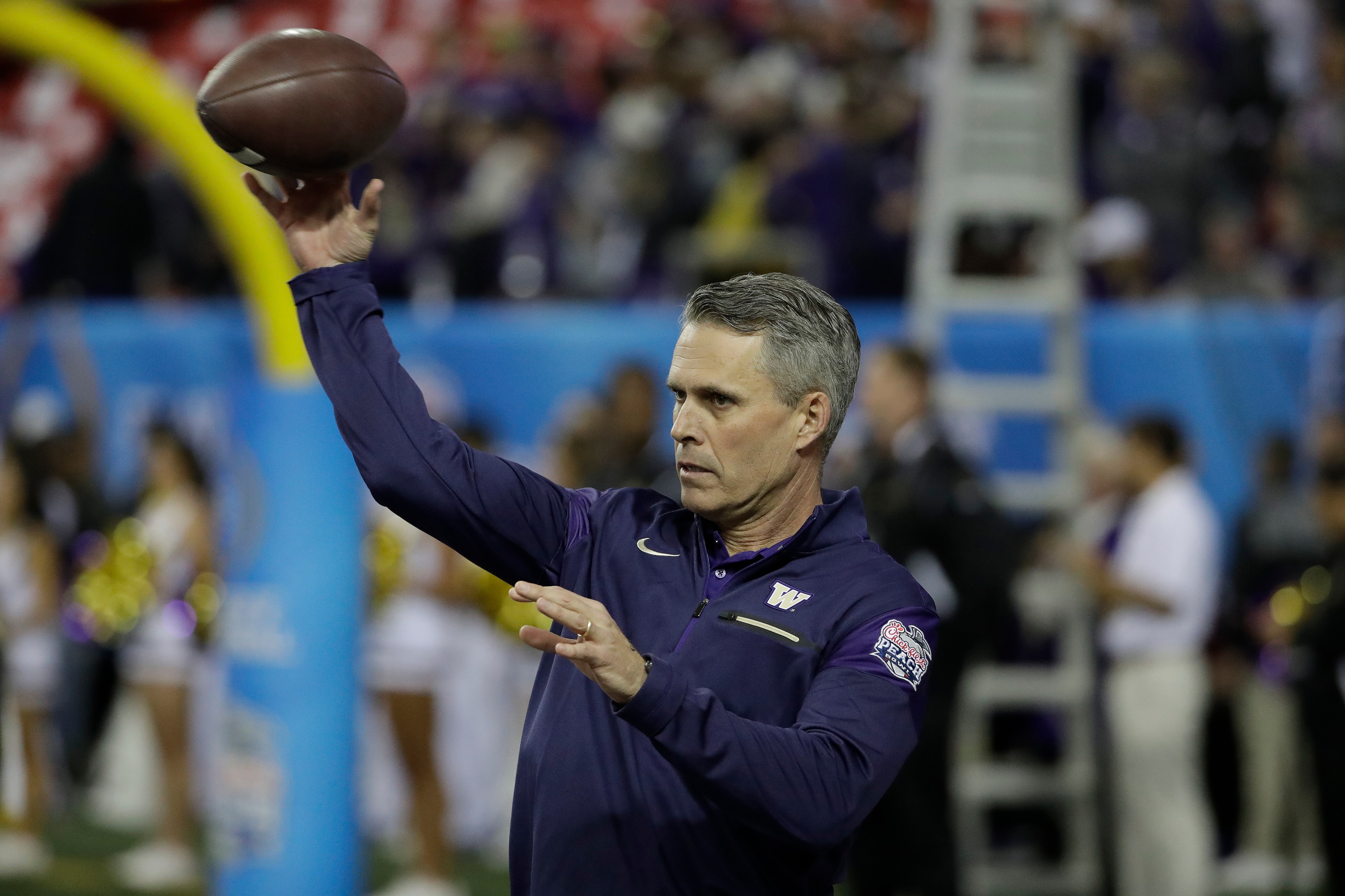 Chris Petersen steered Washington to the CFP semifinals last year.
