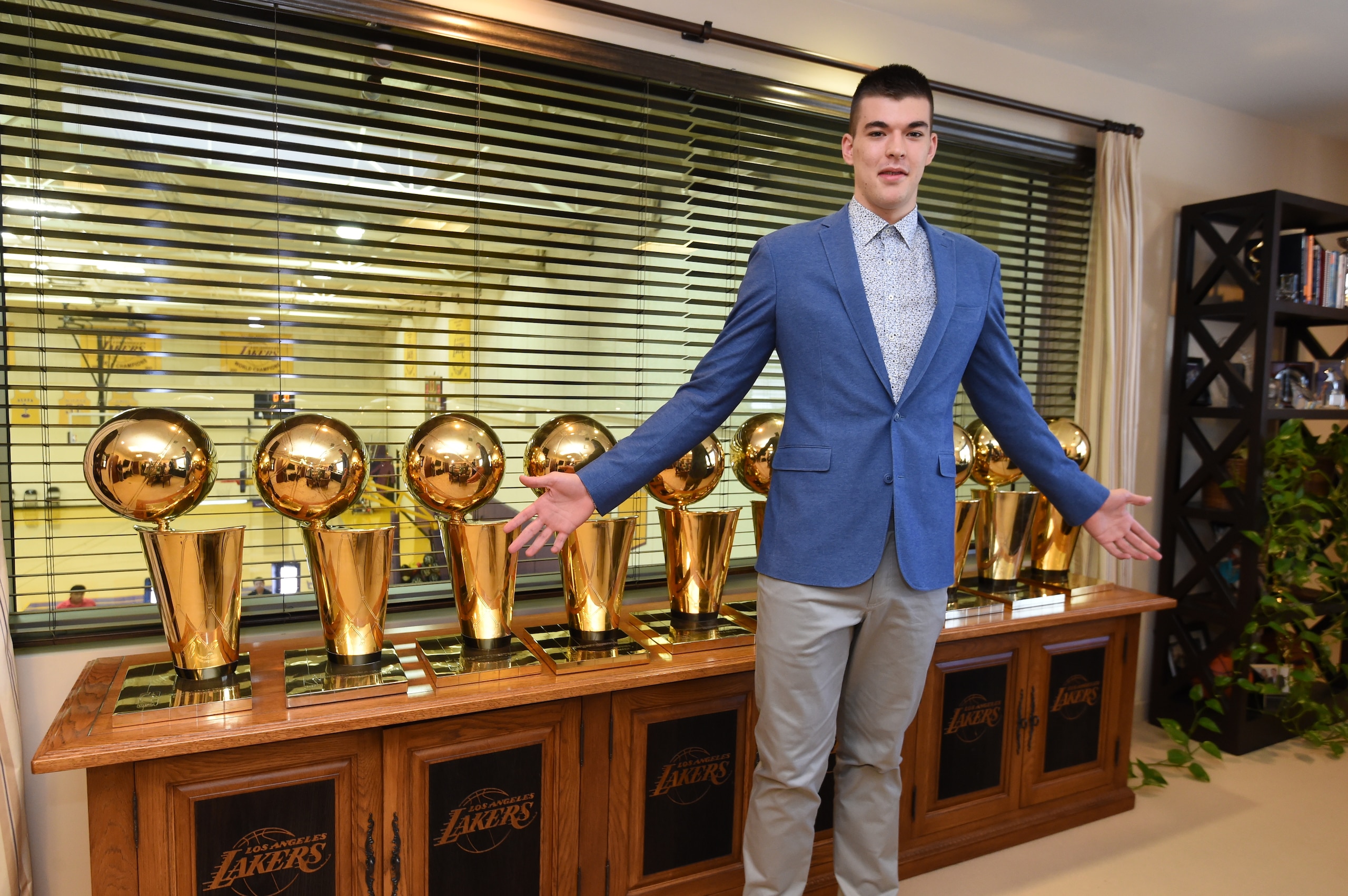 Zubac is introduced to some Lakers hardware after being drafted.