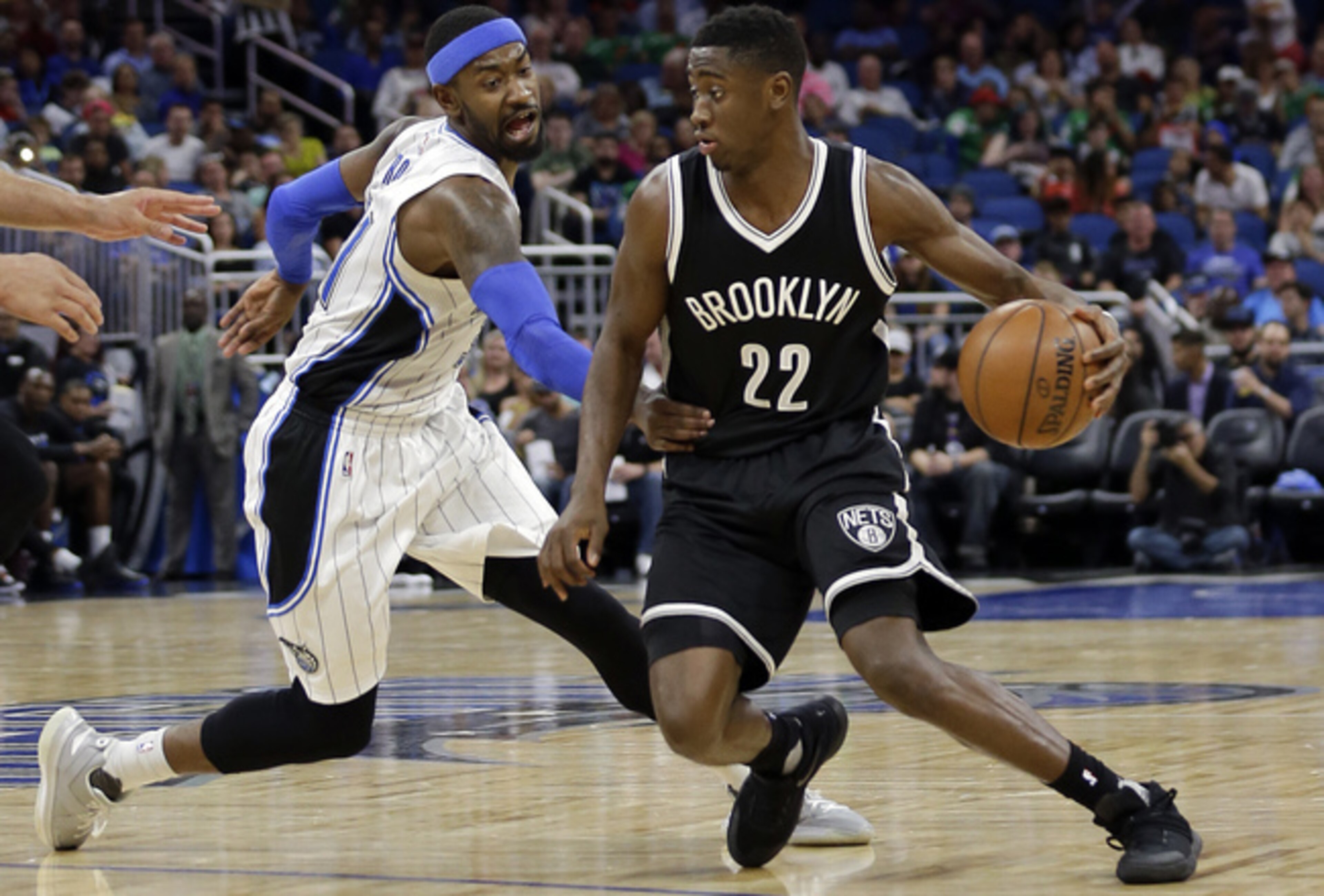 Brooklyn's Caris LeVert (22) dribbles around Orlando's Terrence Ross.