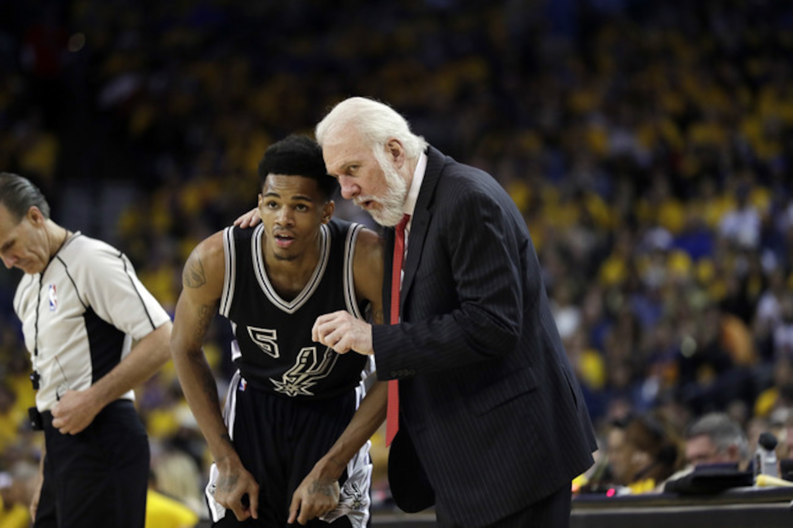 San Antonio's Dejounte Murray listens to head coach Gregg Popovich. San Antonio's Dejounte Murray listens to head coach Gregg Popovich.