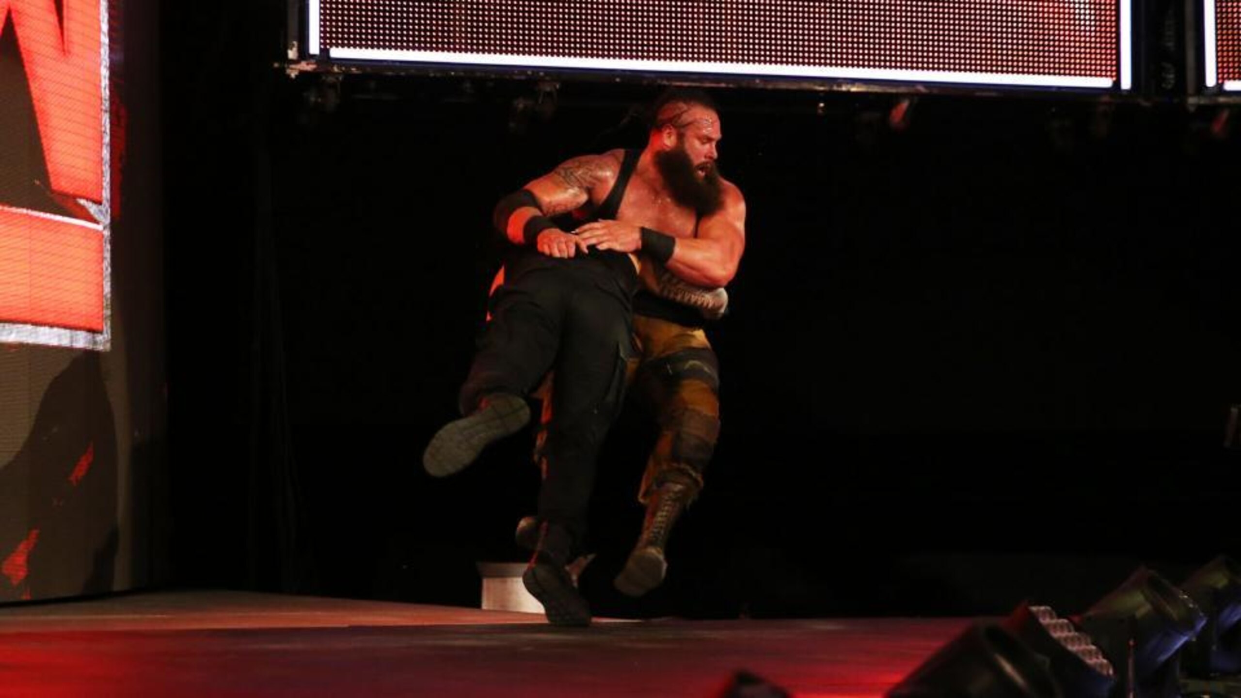 Roman Reigns spears Braun Strowman.