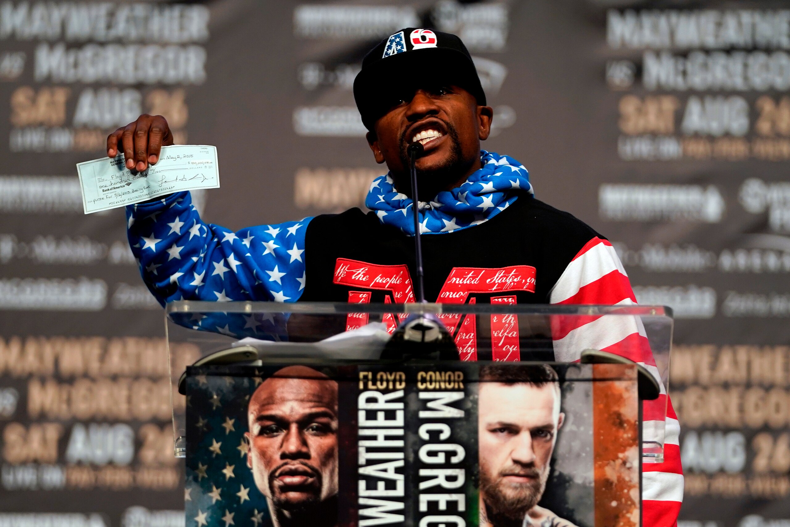 Floyd Mayweather holding up a nine-figure check on the first day of the World Tour. Floyd Mayweather holding up a nine-figure check on the first day of the World Tour.
