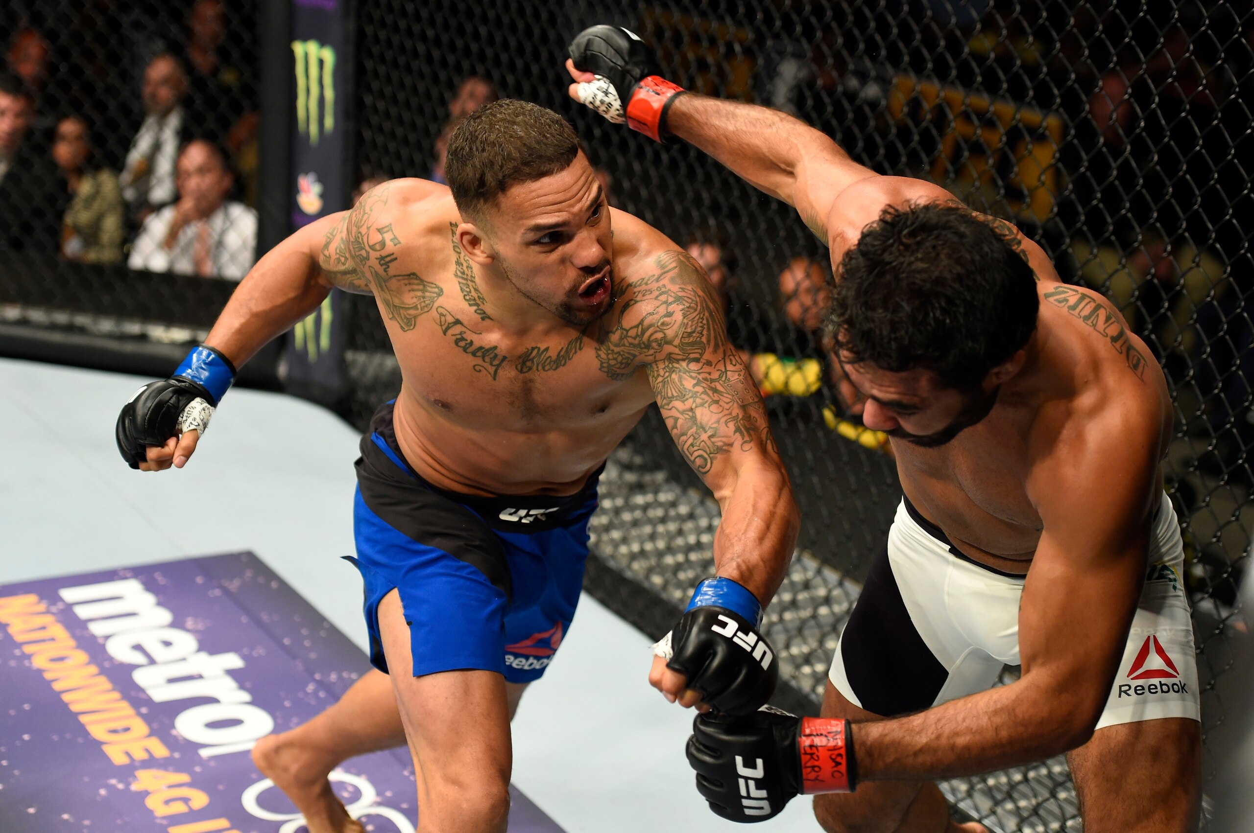 Eryk Anders (left) fells Rafael Natal. Eryk Anders (left) fells Rafael Natal.