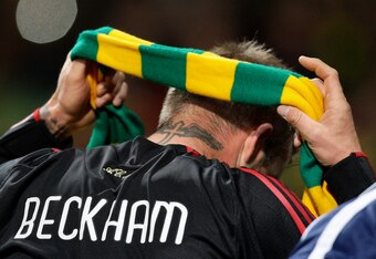 David Beckham dons an anti-Glazer protest scarf.