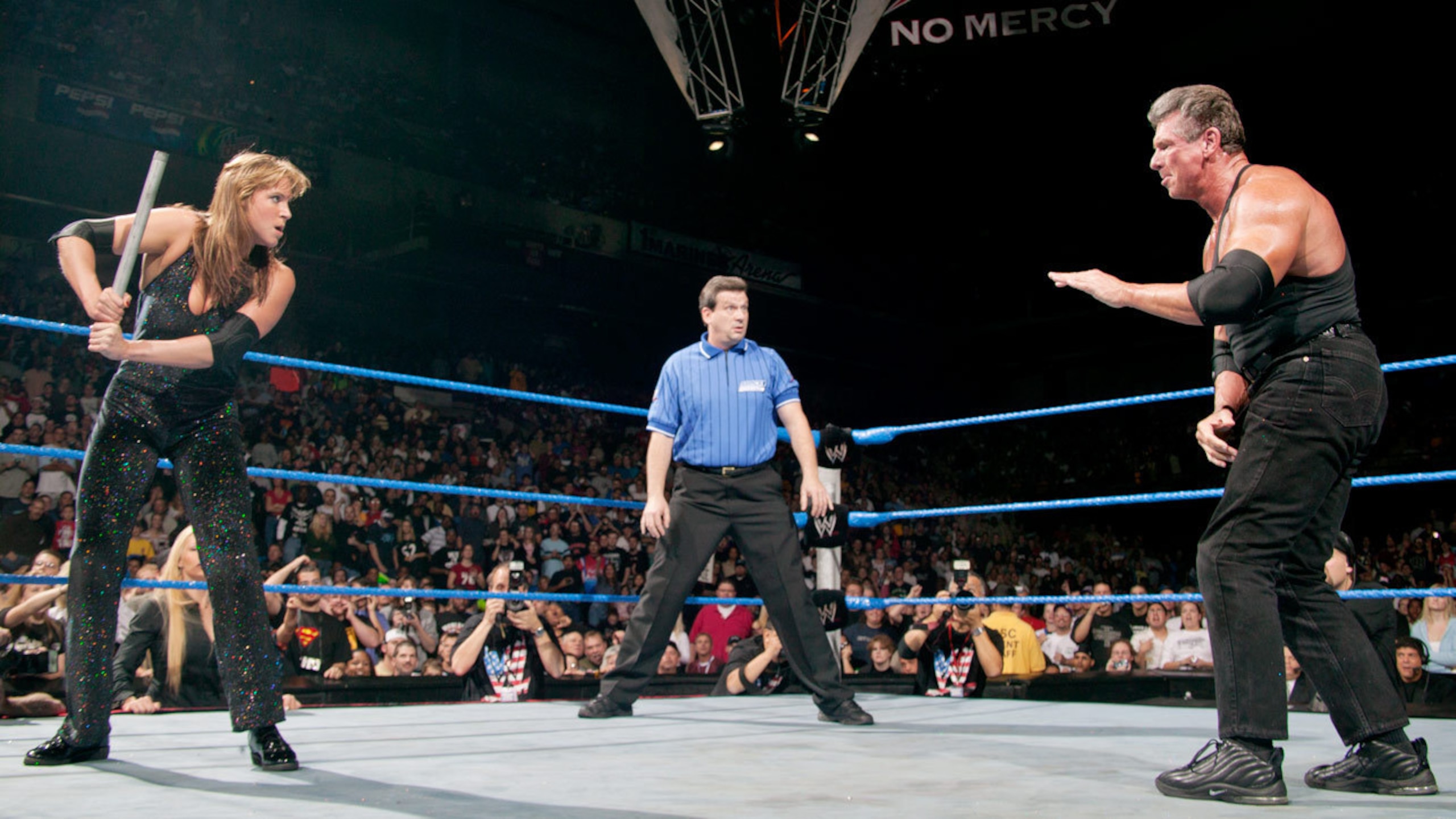 Stephanie prepares to hit Vince with a lead pipe.