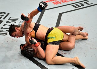 Jessica Andrade (top) punches Claudia Gadelha.