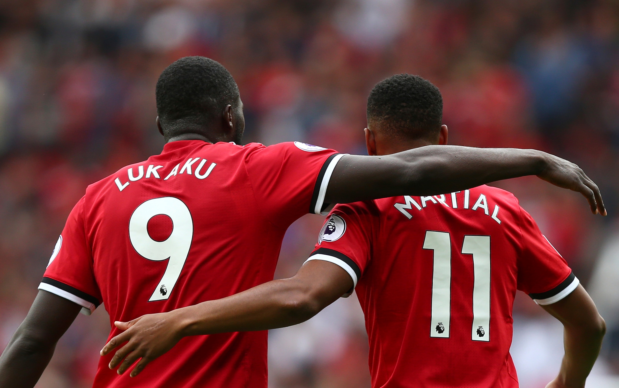 Two United forwards share a hug. Two United forwards share a hug.