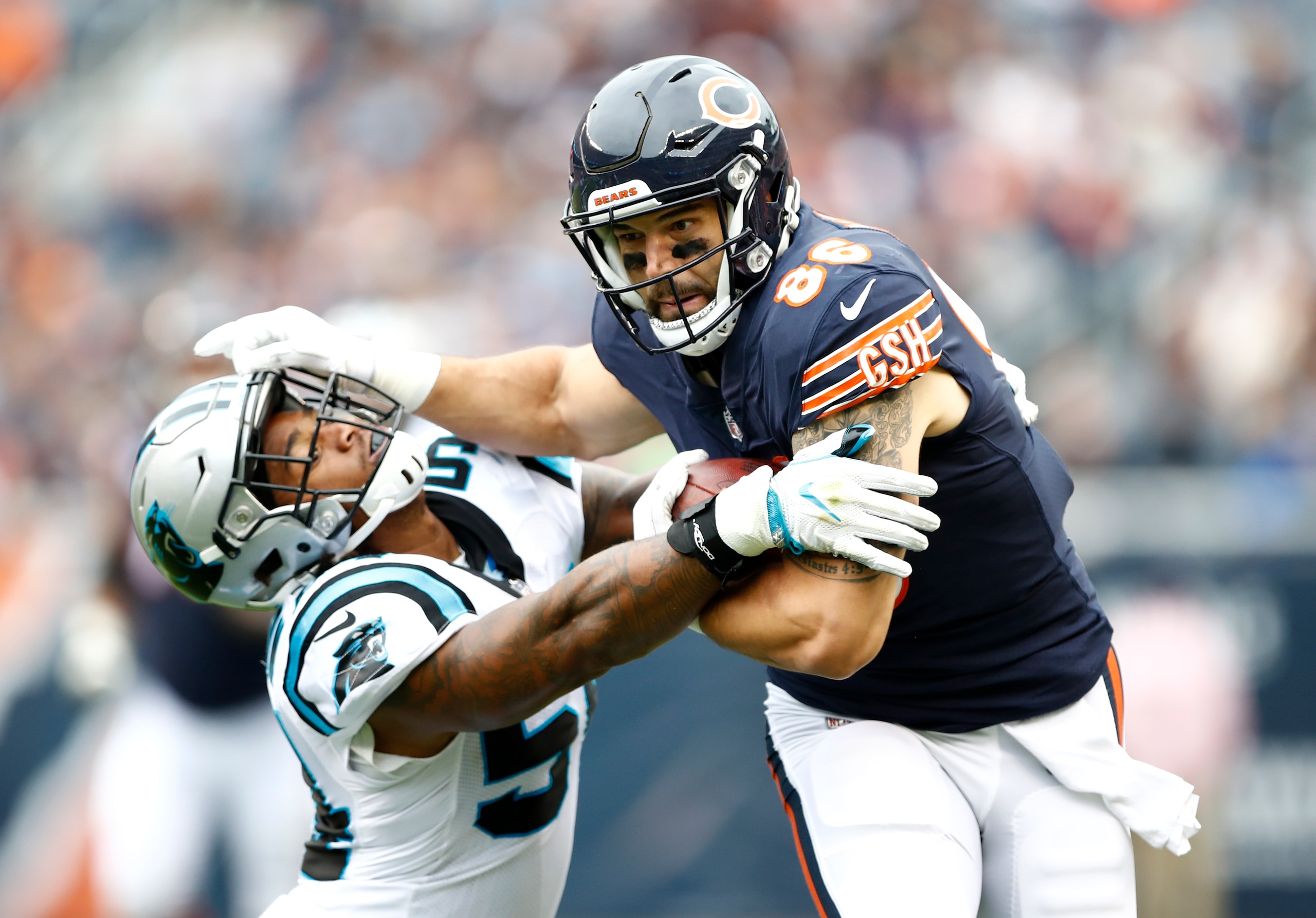 CHICAGO, IL - OCTOBER 22:  Zach Miller #86 of the Chicago Bears carries the football against Shaq Thompson #54 of the Carolina Panthers in the first quarter at Soldier Field on October 22, 2017 in Chicago, Illinois.  (Photo by Wesley Hitt/Getty Images)