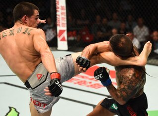 Ryan Benoit (left) kicks Ashkan Mokhtarian