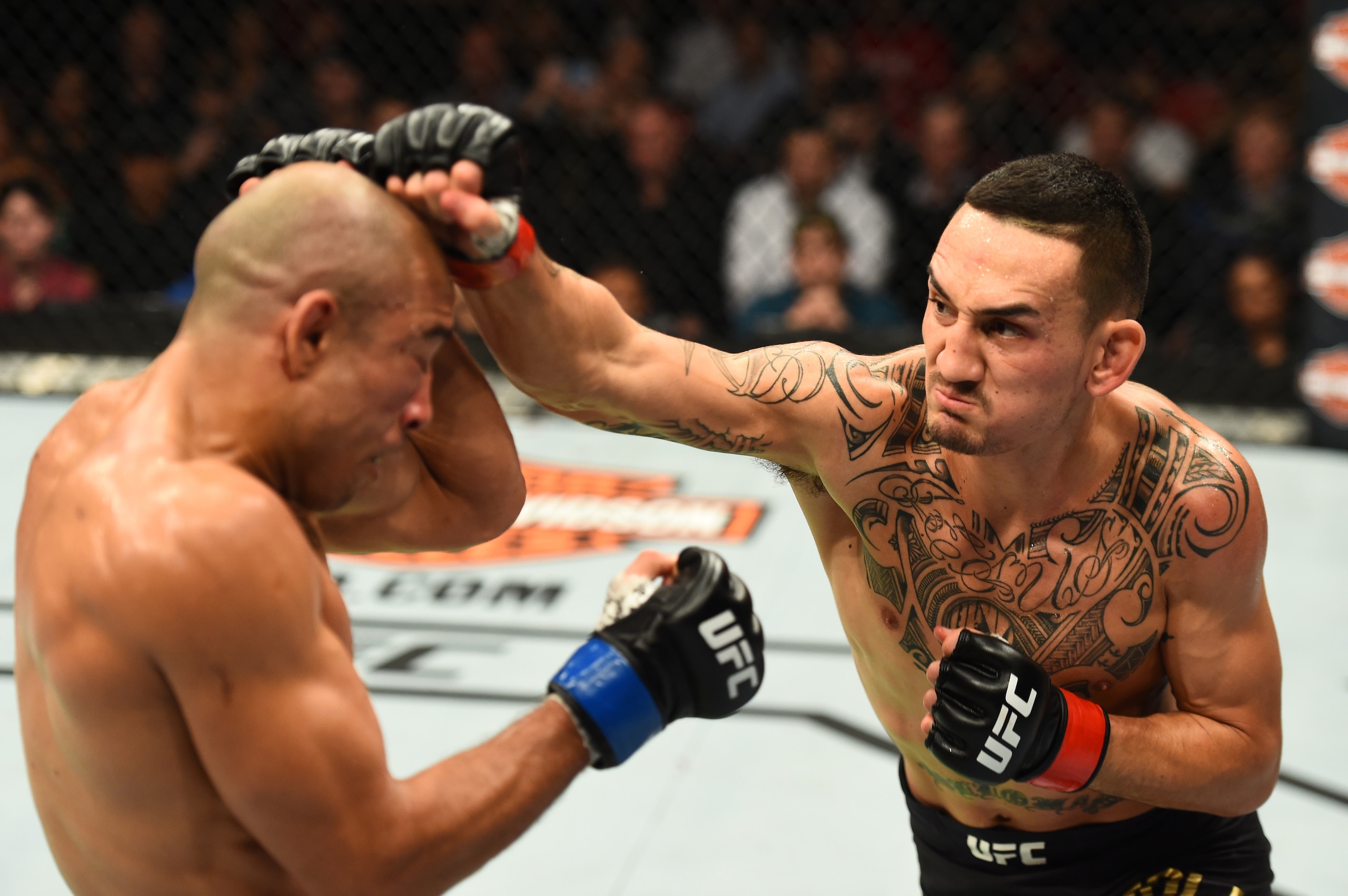 Max Holloway (right) hits Jose Aldo. Max Holloway (right) hits Jose Aldo.