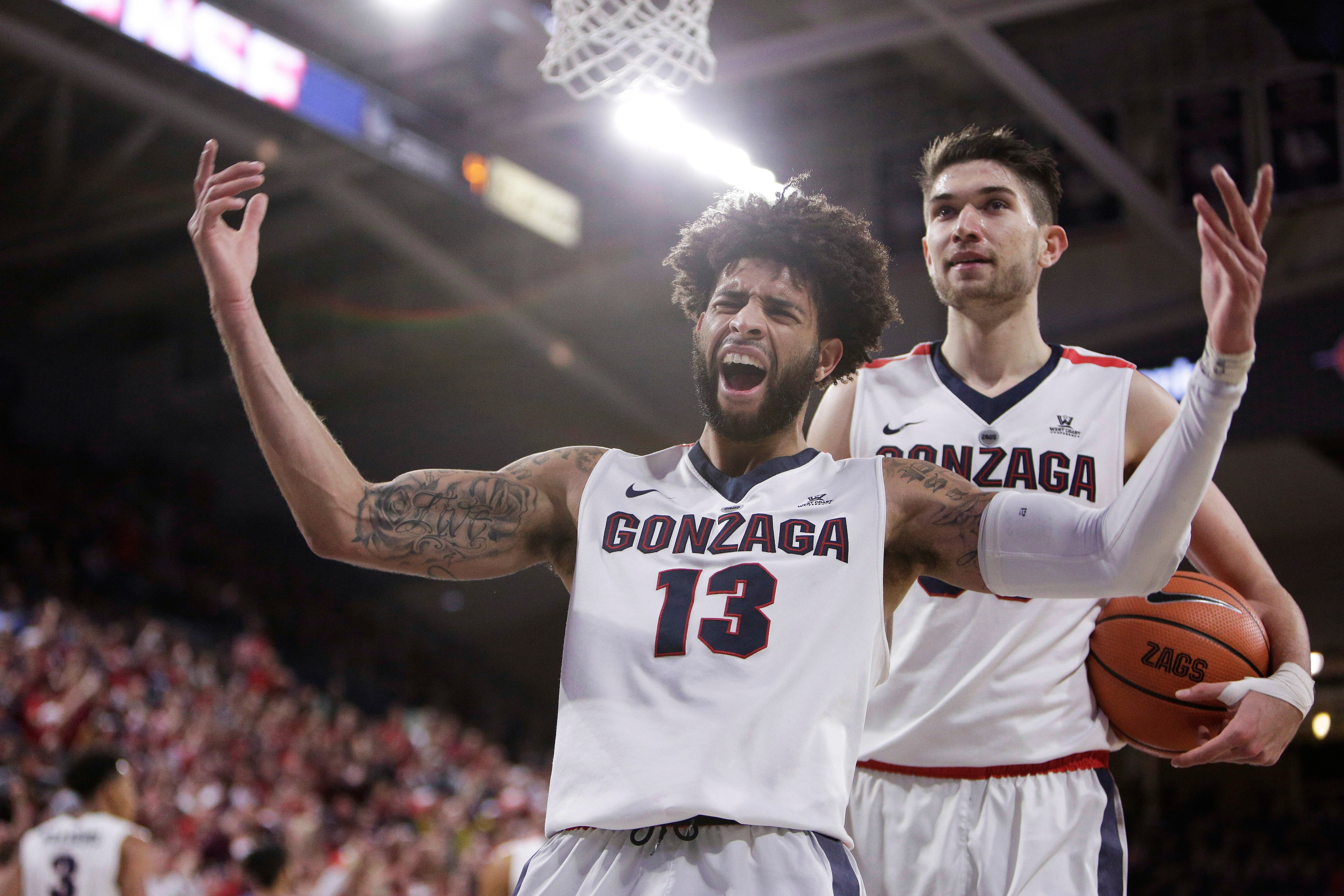 Josh Perkins (13) and Killian Tillie