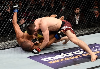 Khabib Nurmagomedov (top) pounds on Edson Barboza (bottom).
