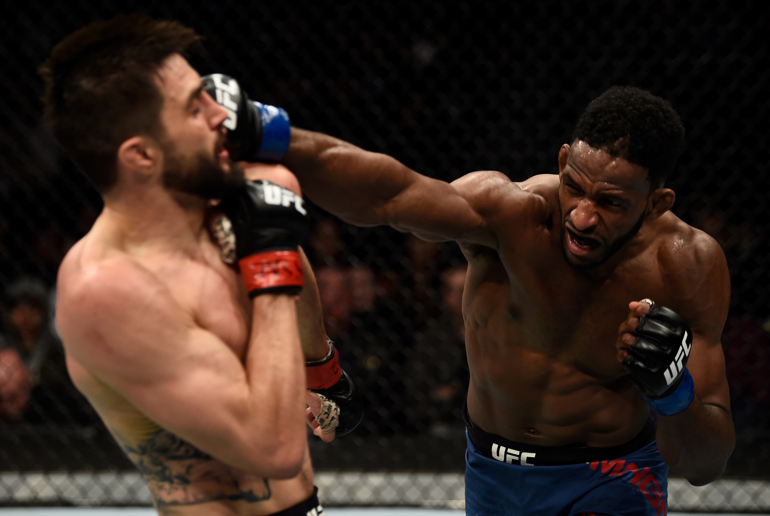 Neil Magny (right) hits Carlos Condit