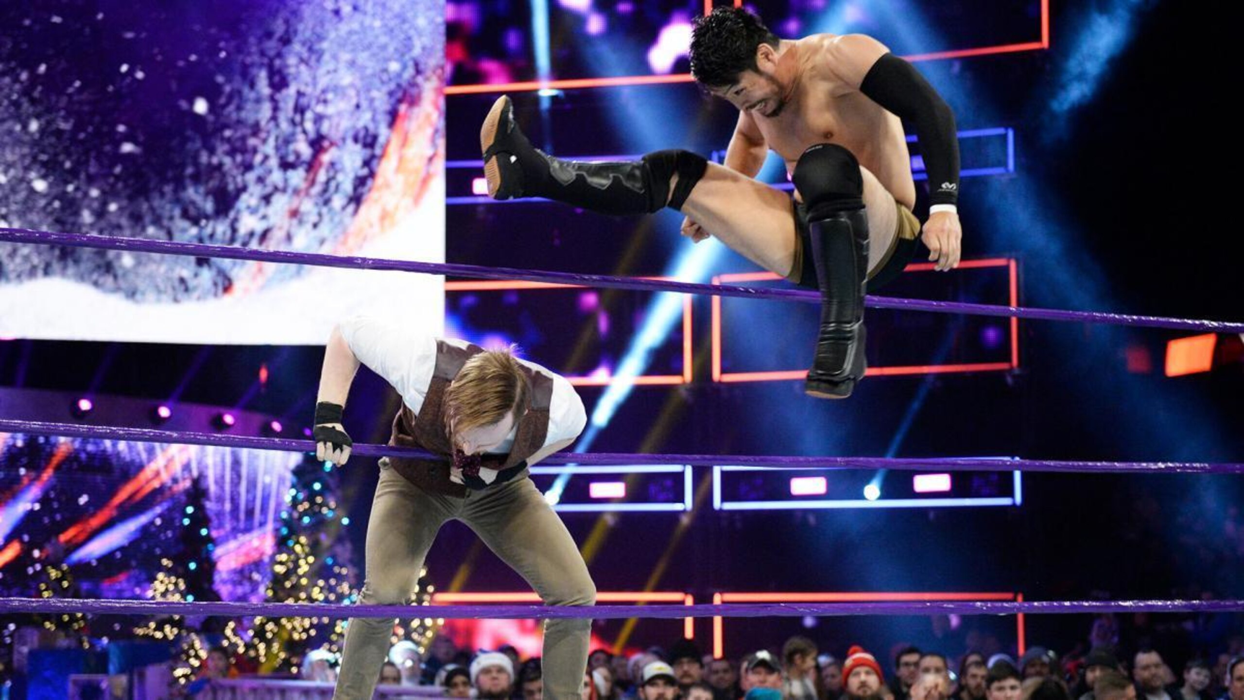 Hideo Itami takes out Jack Gallagher with a leg drop from the top rope.