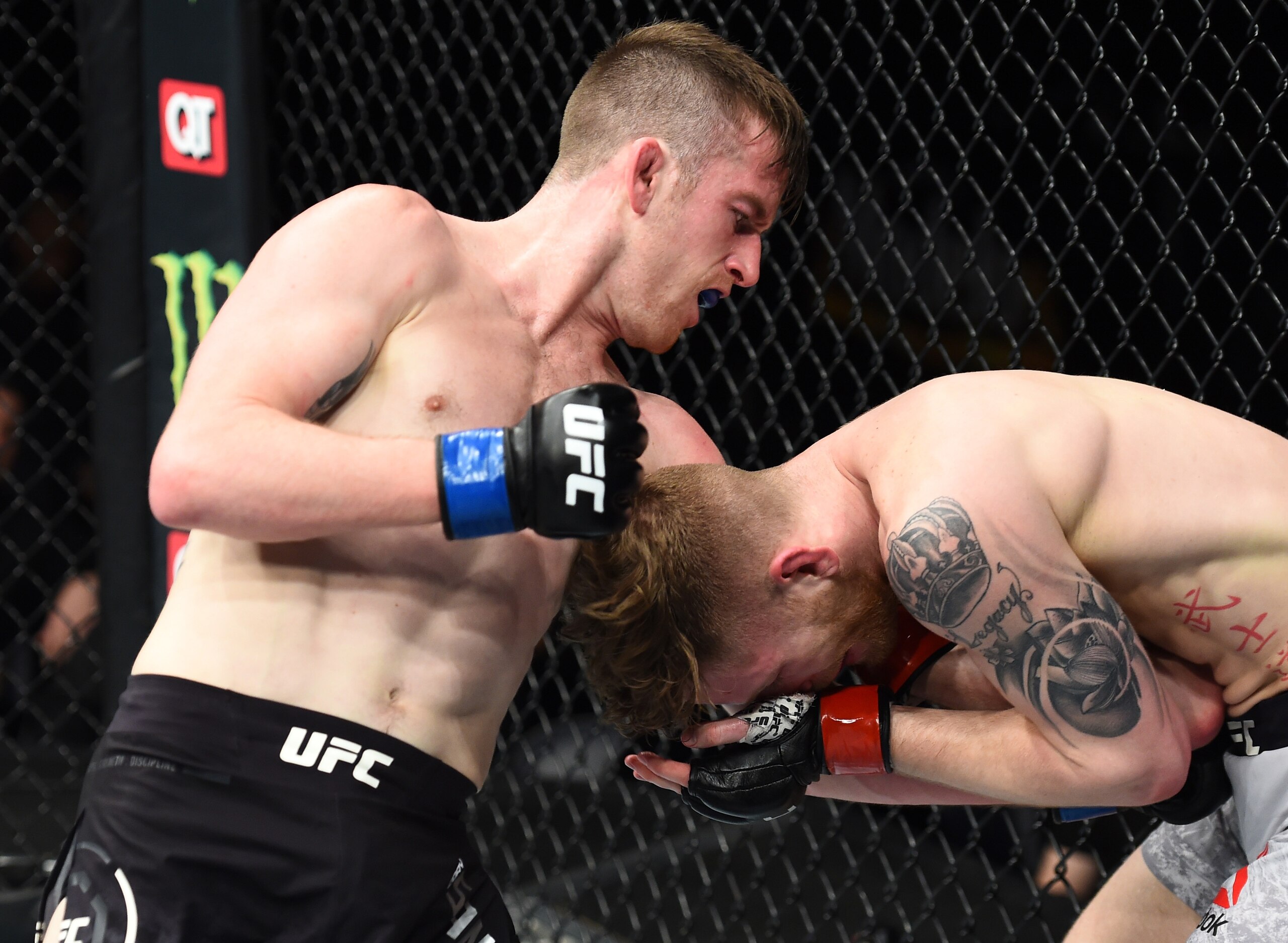 Cory Sandhagen (left) lands a liver shot on Austin Arnett.
