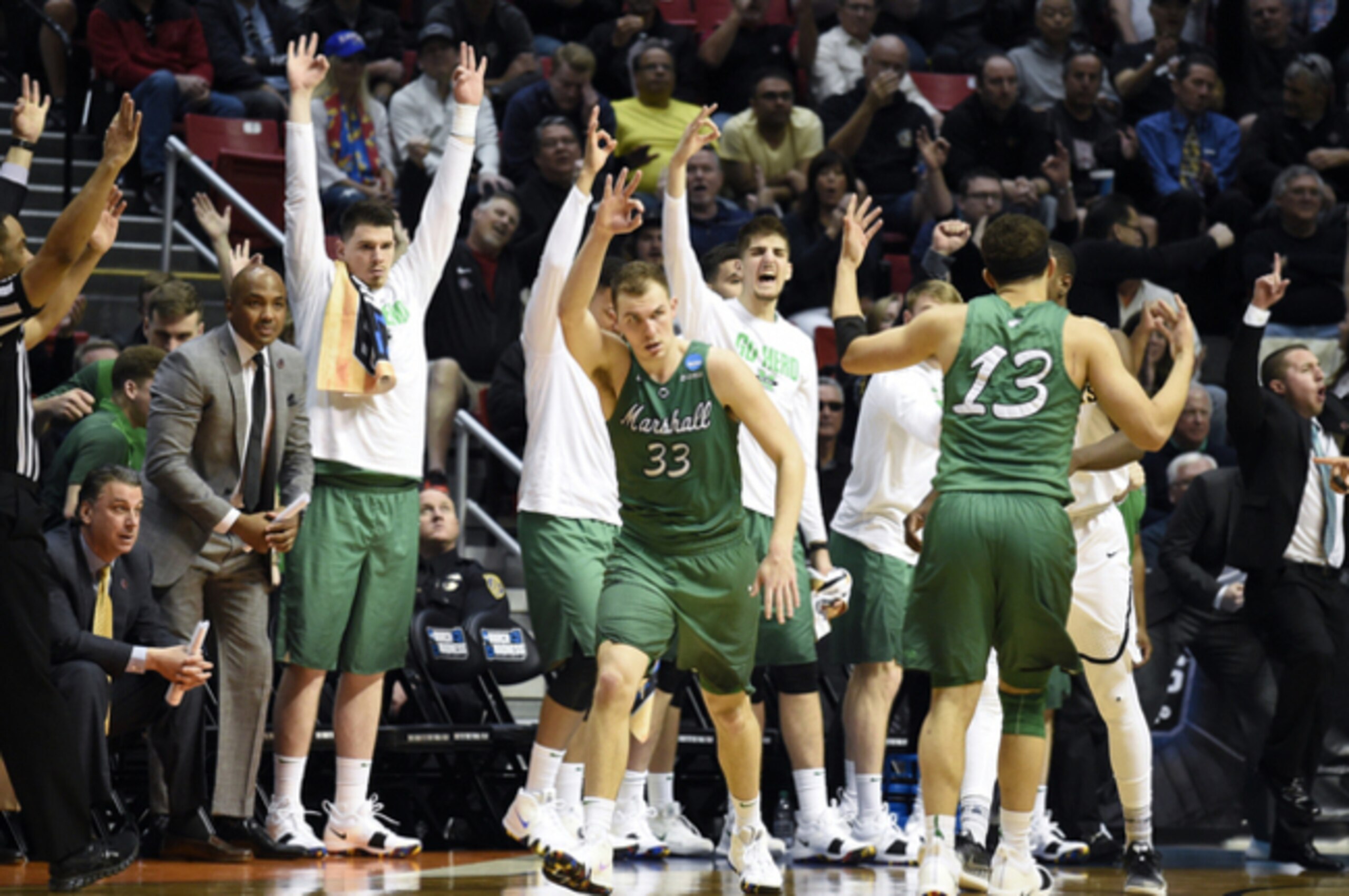 Jon Elmore (No. 33) celebrates after Jarrod West (No. 13) hit a crucial three-pointer.