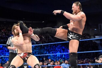 Big Cass kicks Daniel Bryan in the face.