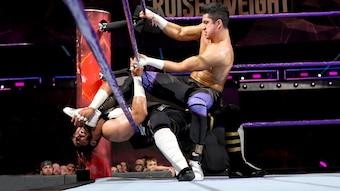 TJP choking Mustafa Ali with his boot.