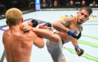 Sergio Pettis (right) kicks Joseph Benavidez