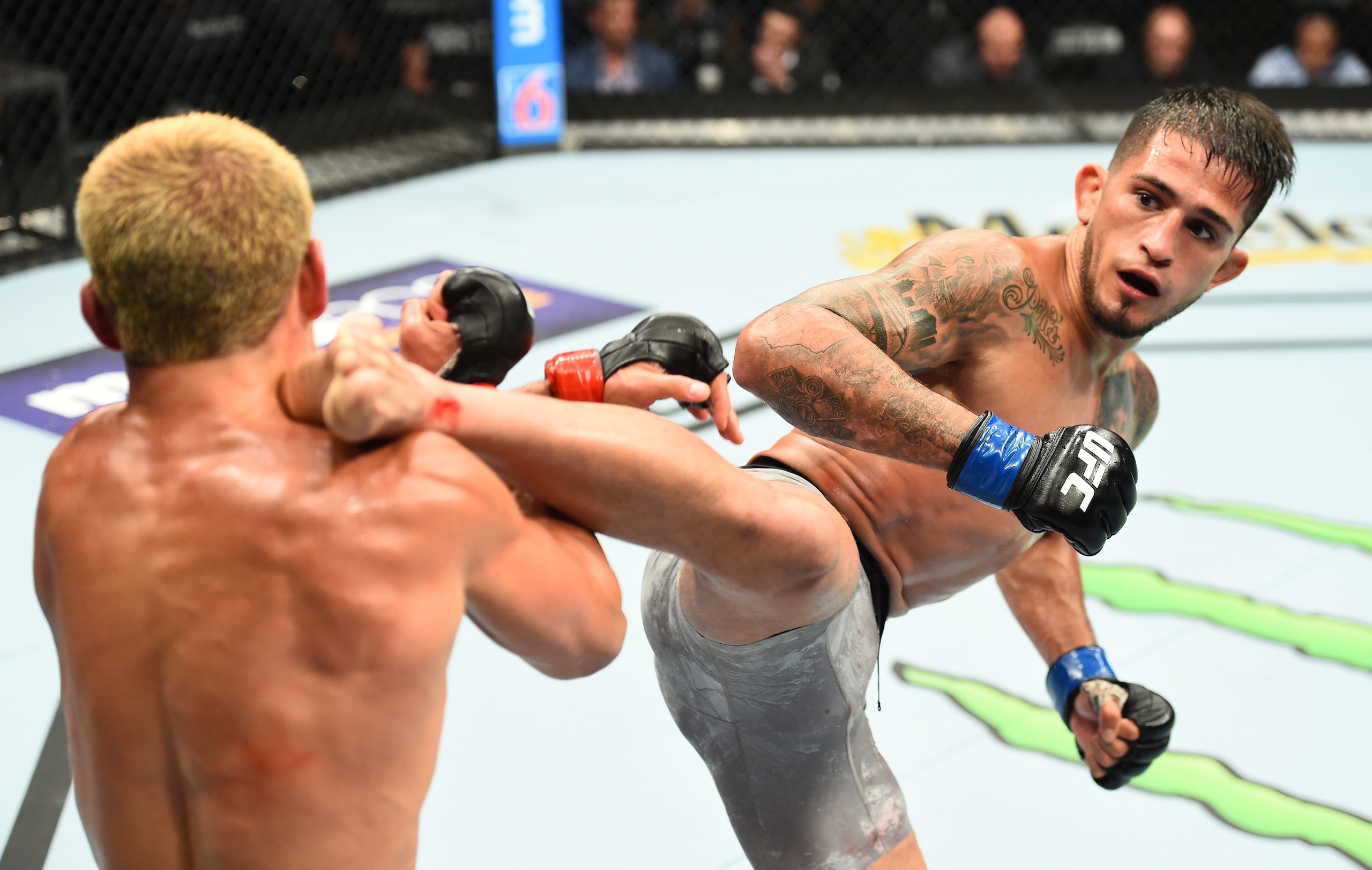 Sergio Pettis (right) kicks Joseph Benavidez