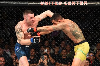 Colby Covington (left) punches Rafael dos Anjos
