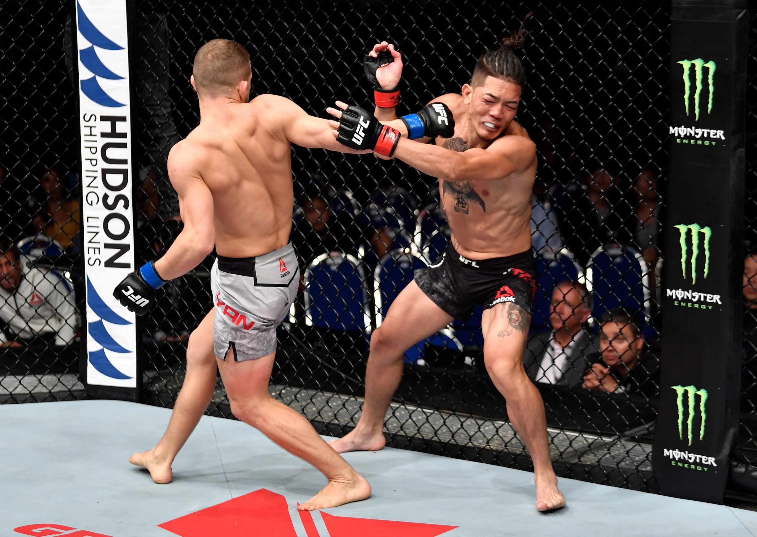 Petr Yan (left) lands a spinning backfist on Teruto Ishihara.