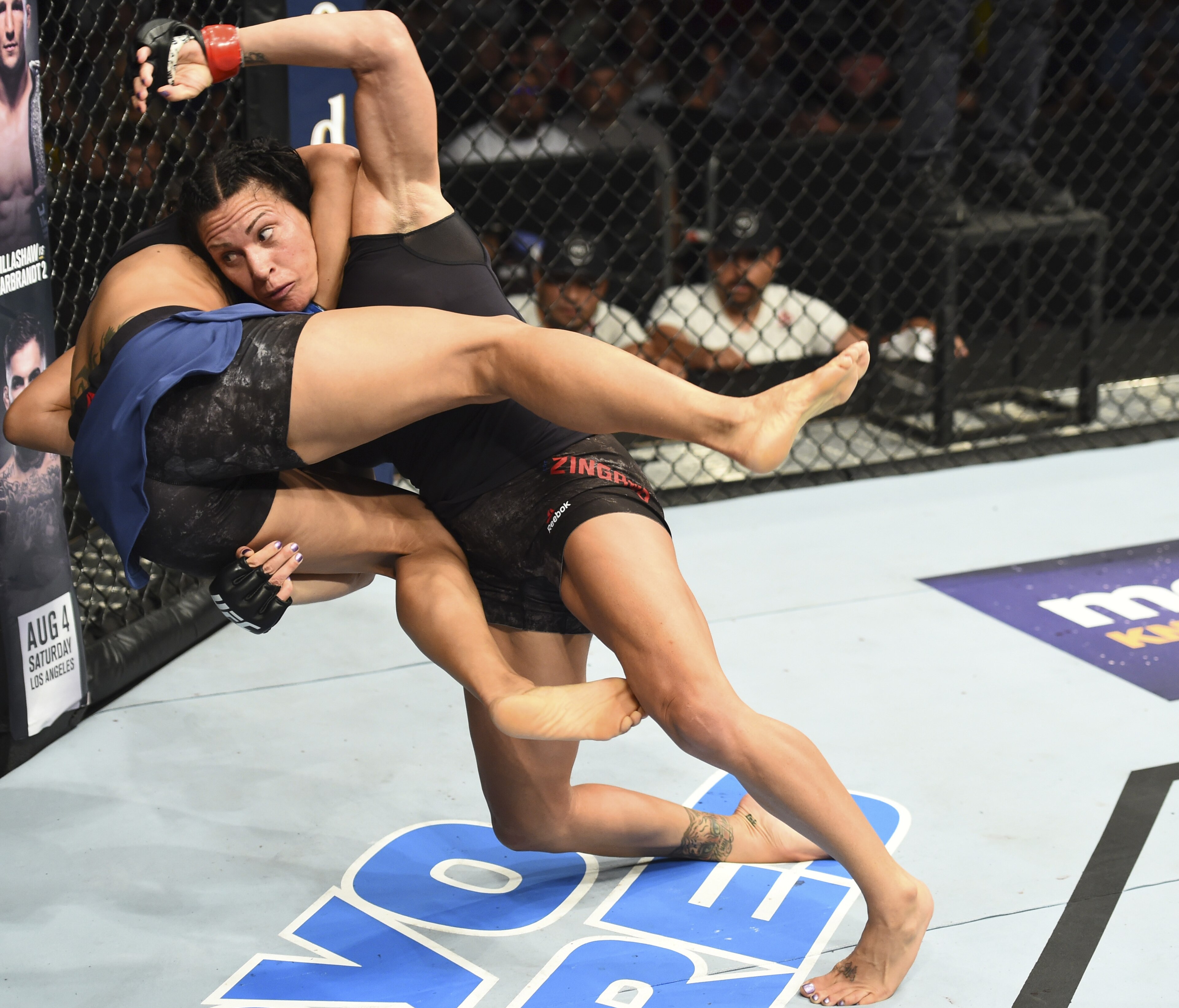 Cat Zingano (right) takes down Marion Reneau.