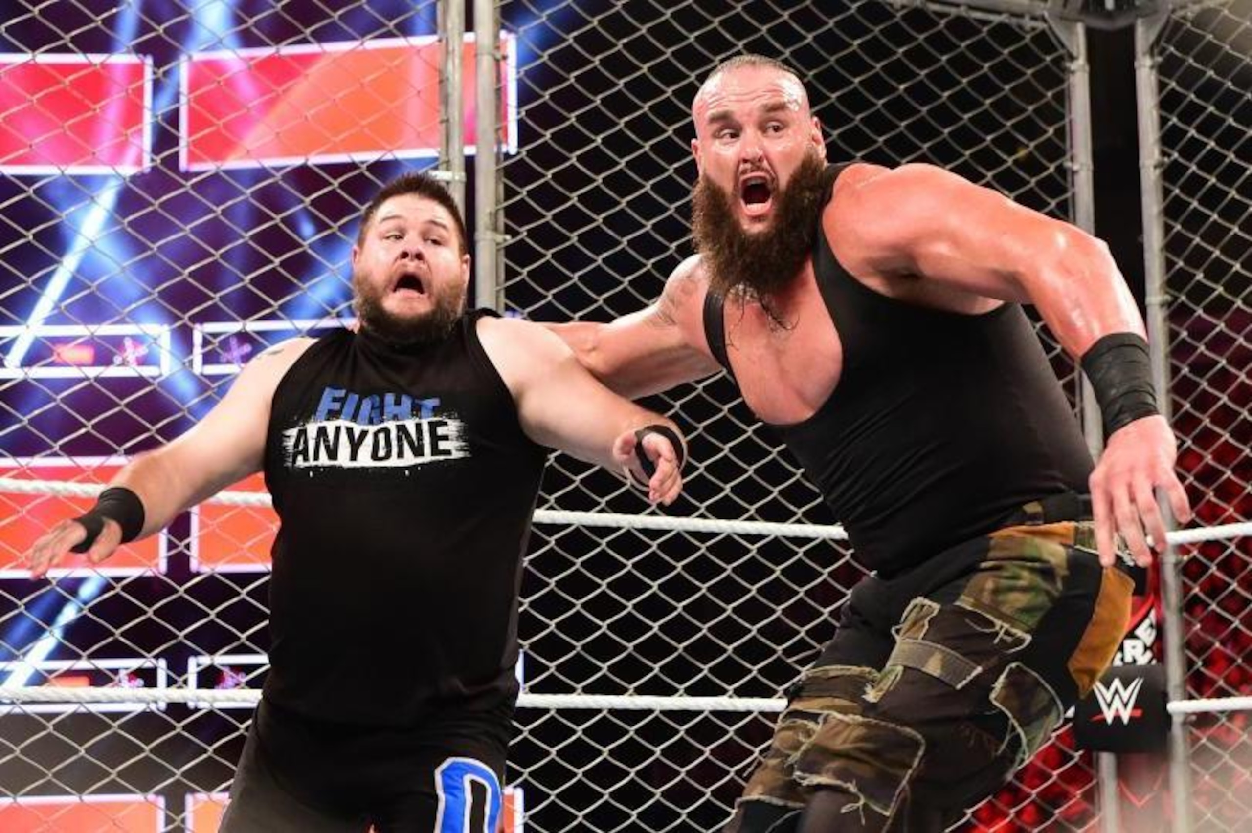 Braun Strowman throws Kevin Owens into the cage wall. Braun Strowman throws Kevin Owens into the cage wall.