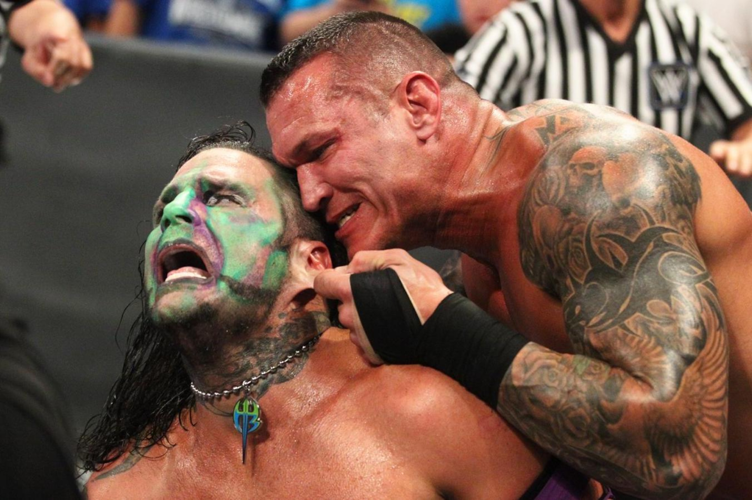 Randy Orton attempting to rip one of Jeff Hardy's earrings out. Randy Orton attempting to rip one of Jeff Hardy's earrings out.