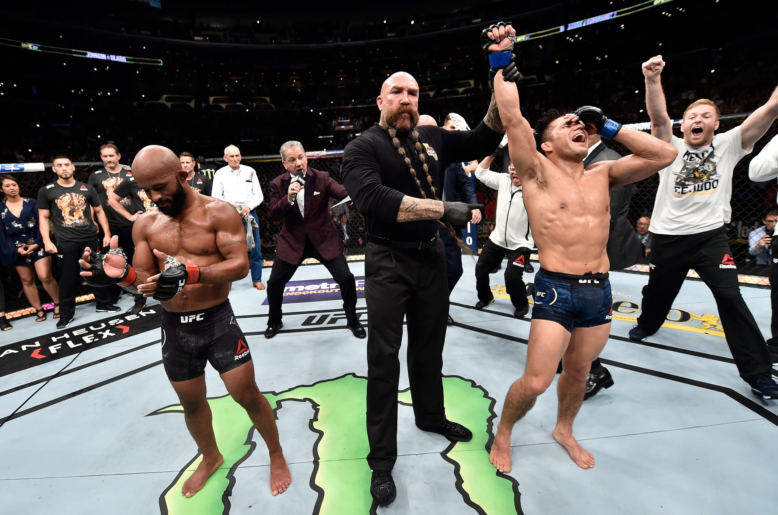 Henry Cejudo (right) reacts to the championship announcement.