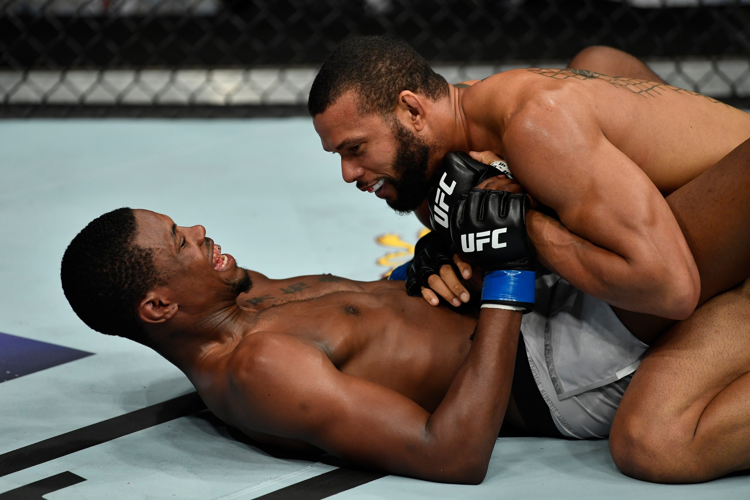 Kevin Holland (below) and Thiago Santos exchange words.