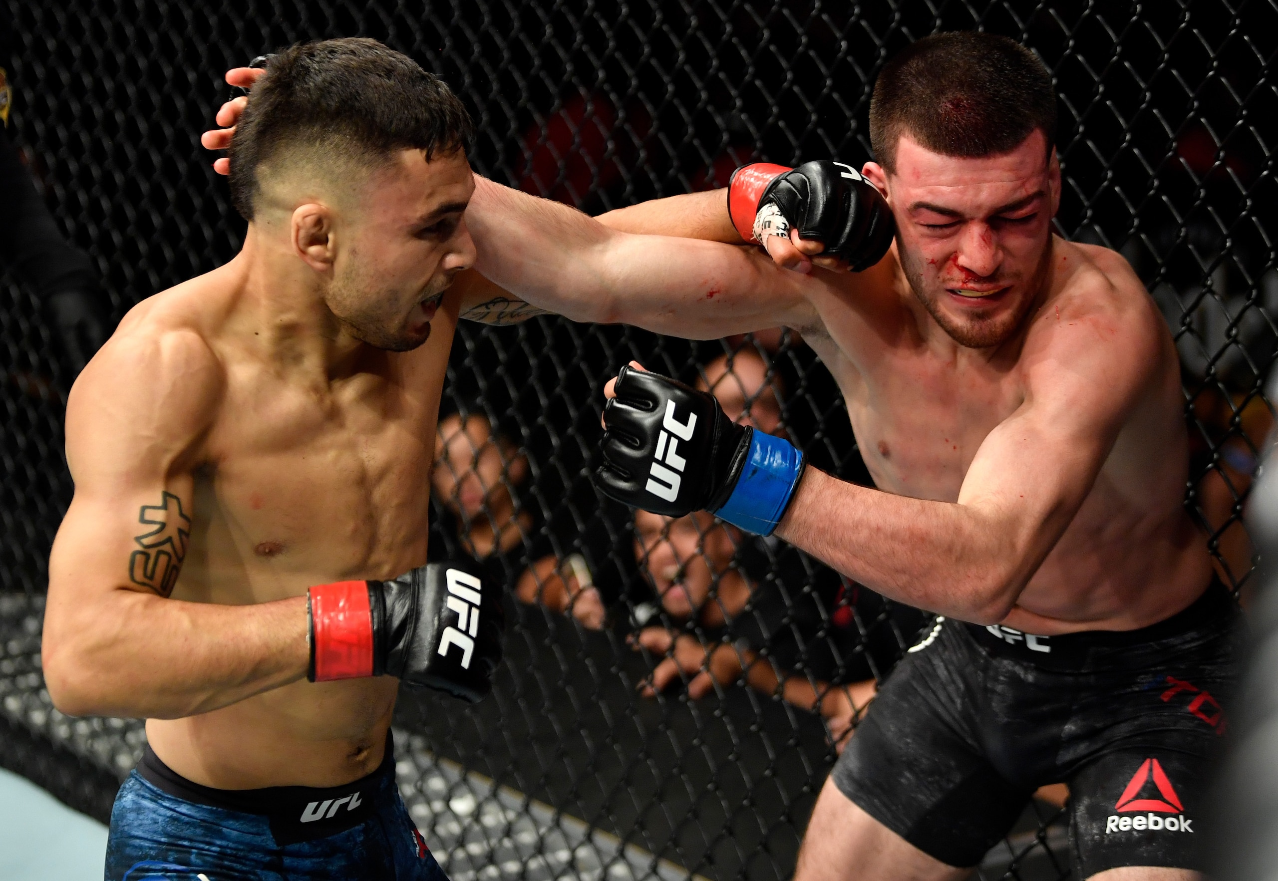 Alex Perez (left) hits Jose Torres