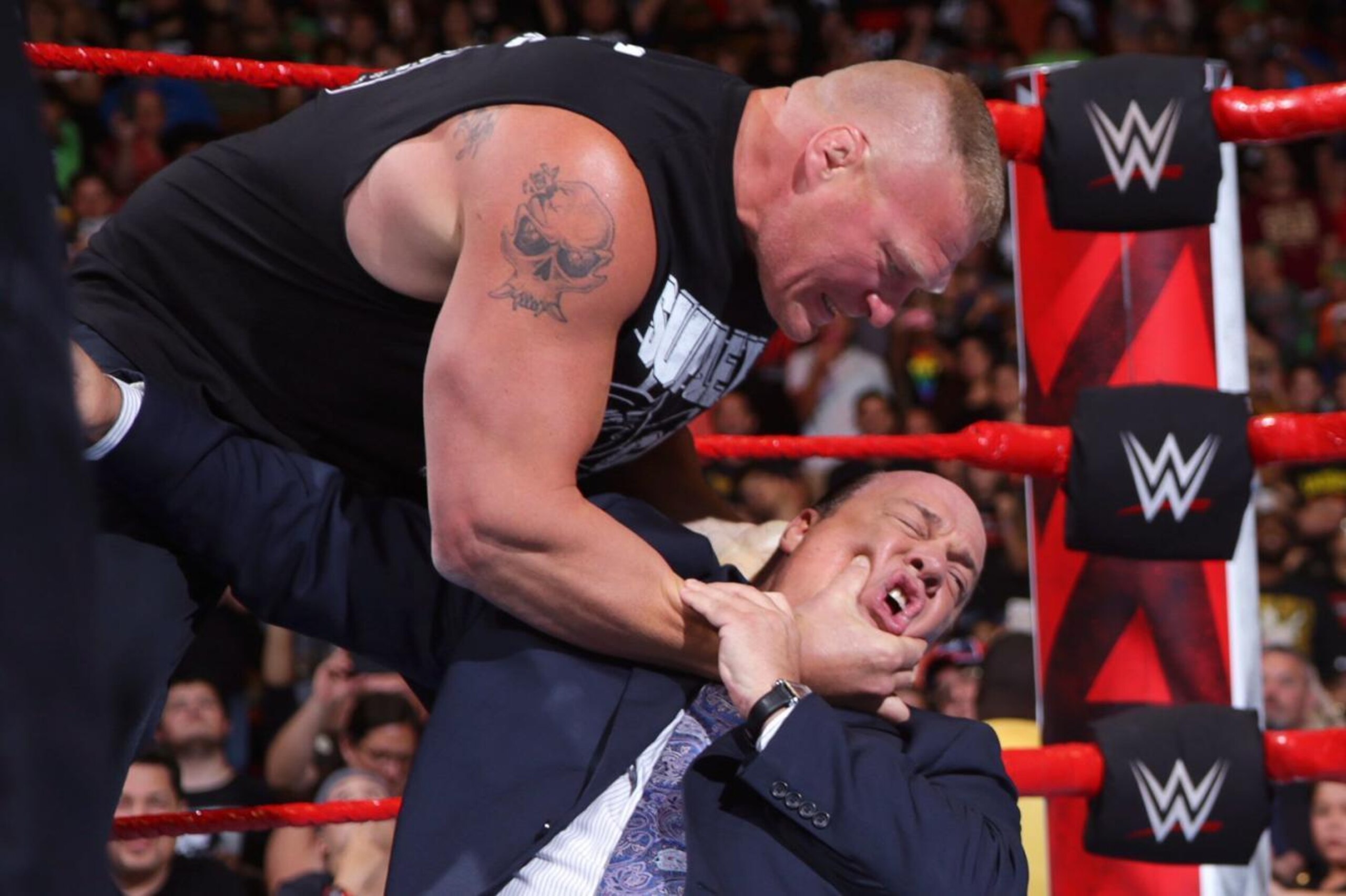 Brock Lesnar choking the life out of Paul Heyman.