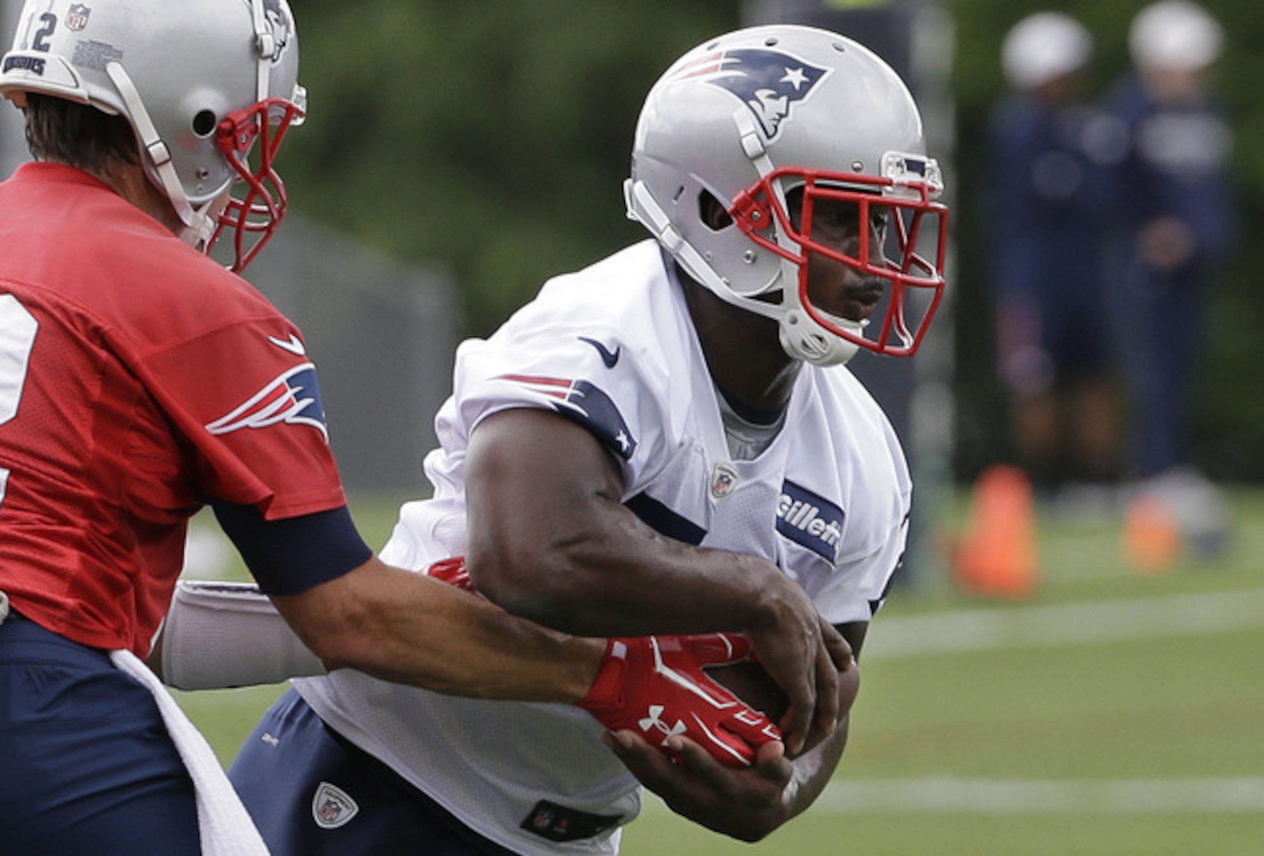 New England Patriots running back Sony Michel takes a handoff from quarterback Tom Brady.