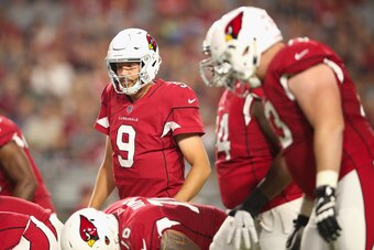 Arizona Cardinals quarterback Sam Bradford lines up behind his offensive line.