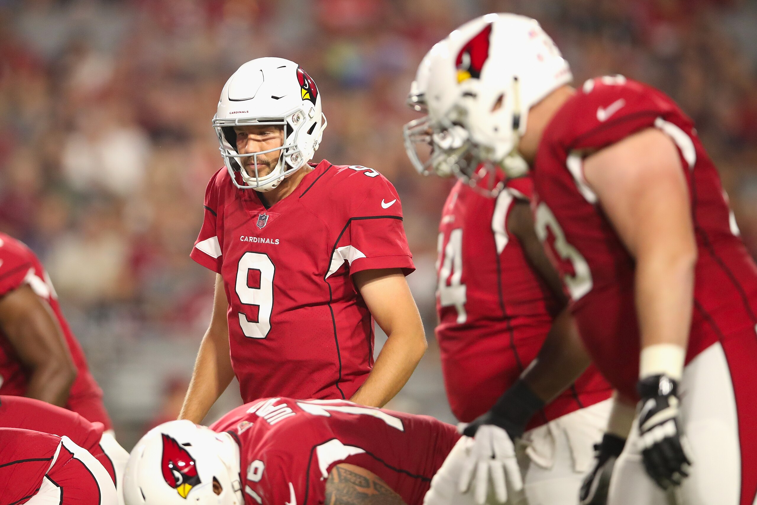 Arizona Cardinals quarterback Sam Bradford lines up behind his offensive line.
