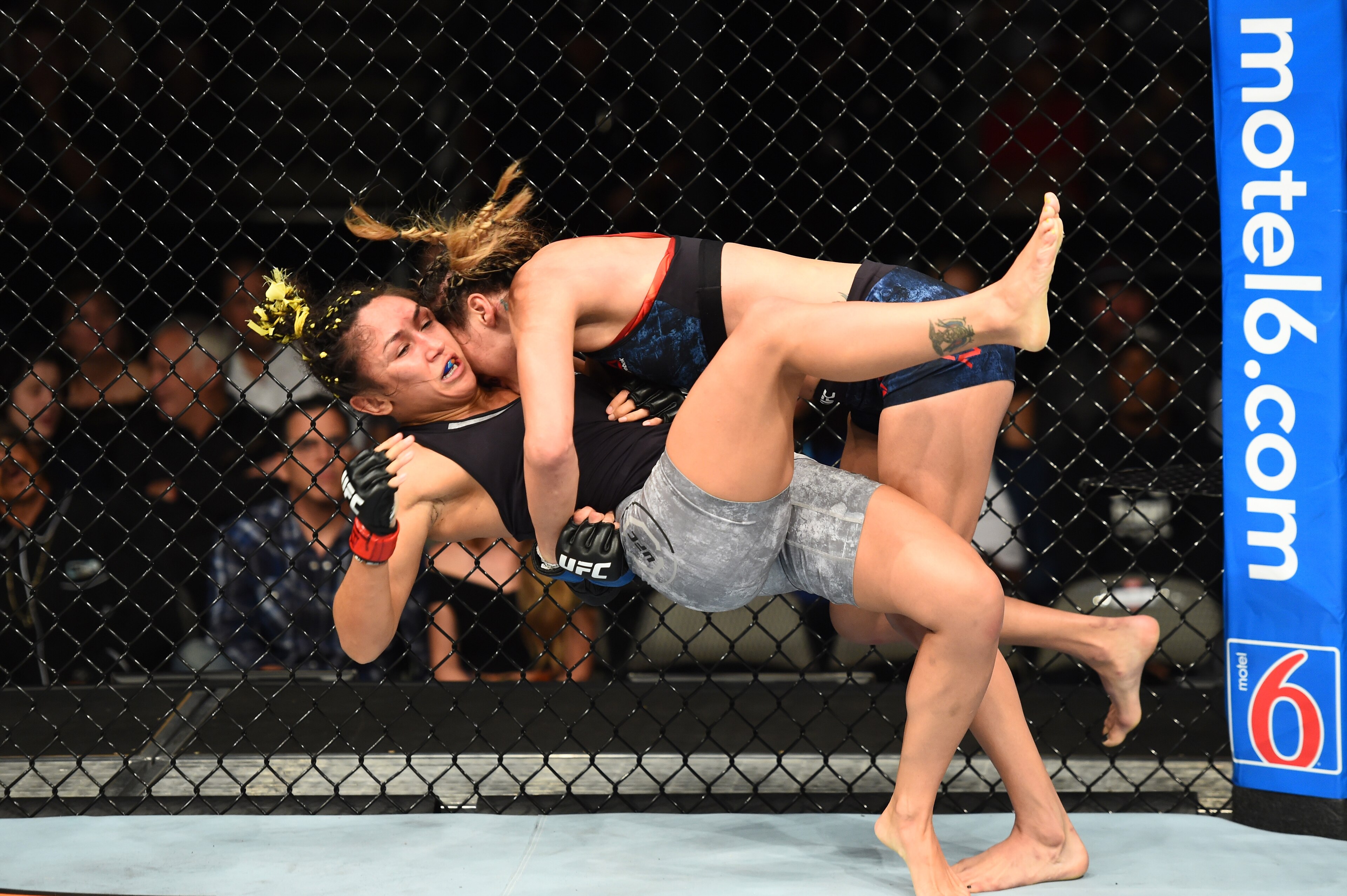 Tatiana Suarez (top) takes down Carla Esparza