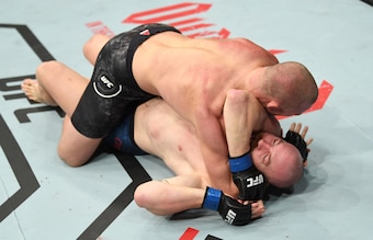 Misha Cirkunov (top) locks on the arm-triangle choke.