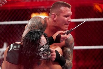Randy Orton about to hurt Jeff Hardy with a screwdriver.