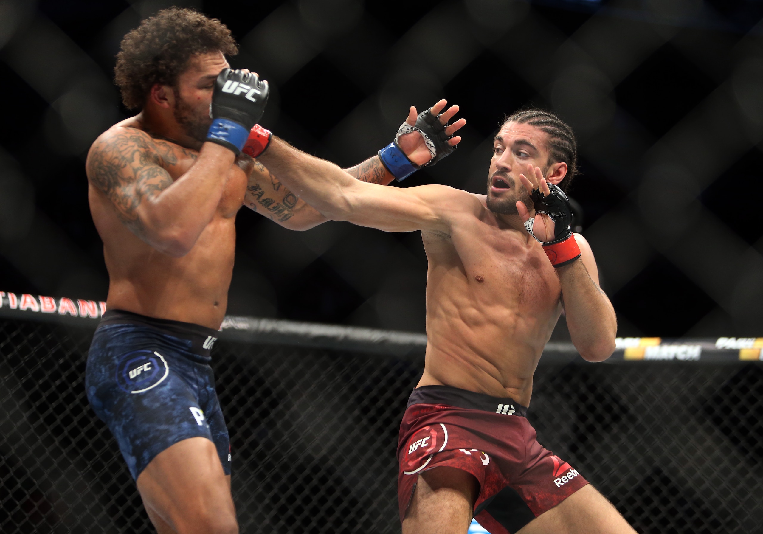 Elias Theodorou (right) hits Eryk Anders