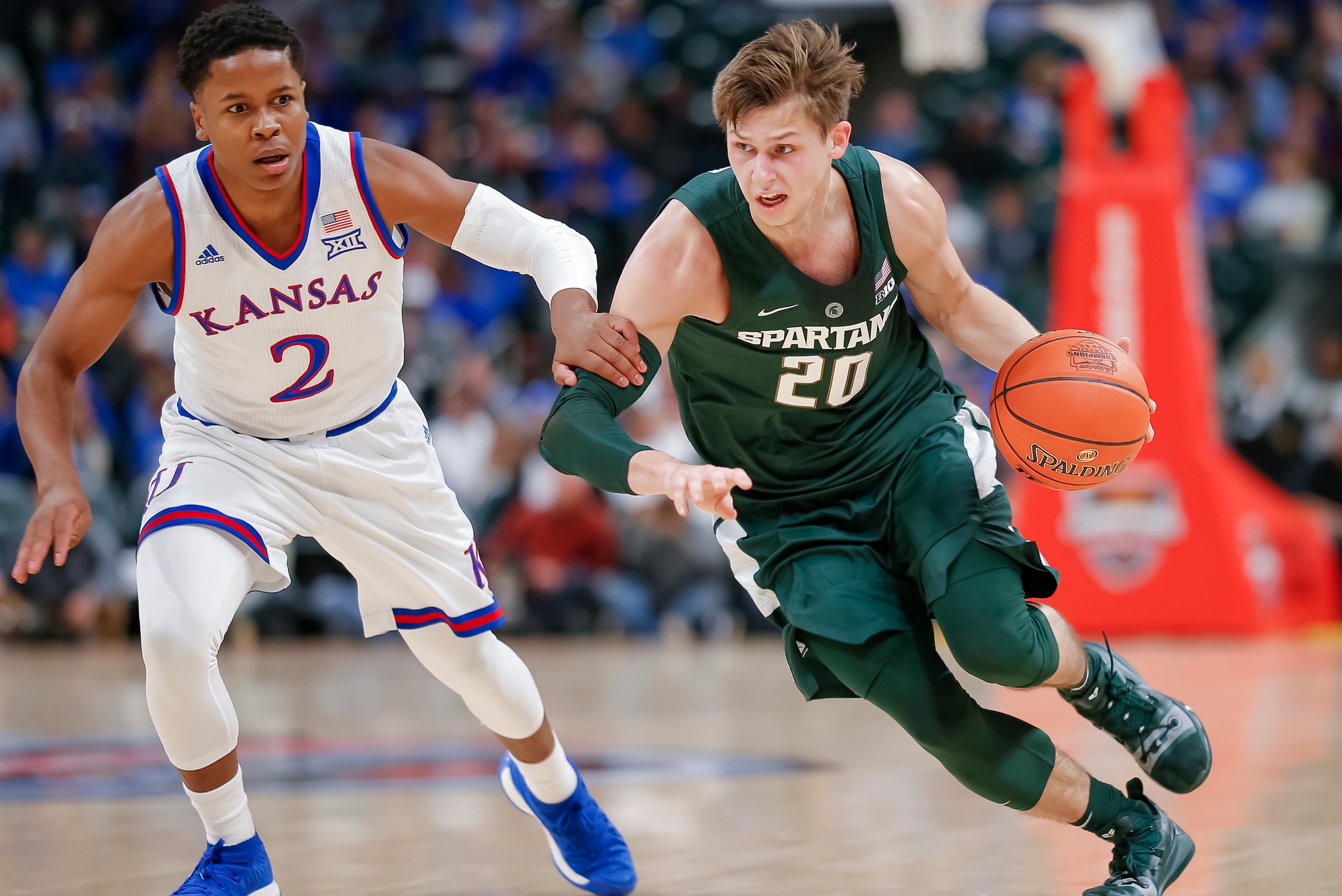 Kansas' Charlie Moore and Michigan State's Matt McQuaid.